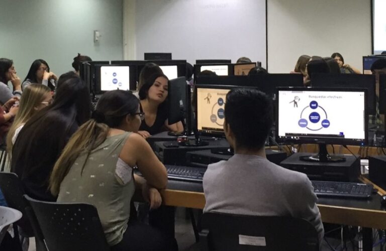 Estudiantes trabajando en un computador.